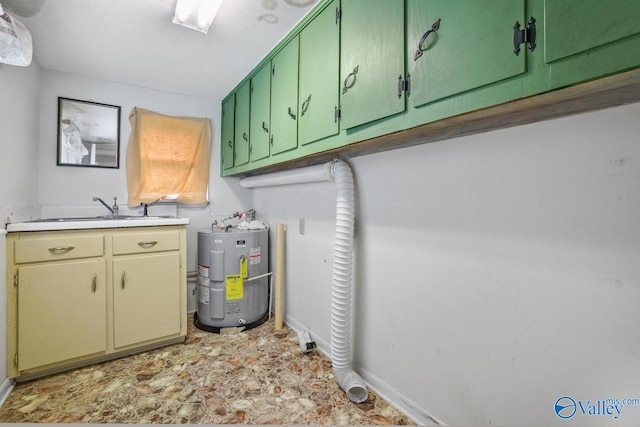 clothes washing area featuring cabinets, sink, and water heater