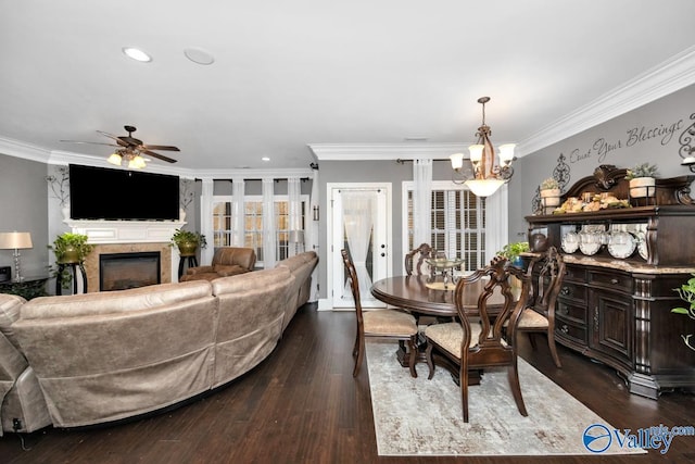 dining space featuring ceiling fan with notable chandelier, dark hardwood / wood-style floors, and ornamental molding