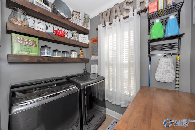 laundry area with washing machine and dryer and crown molding