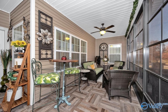 sunroom featuring ceiling fan