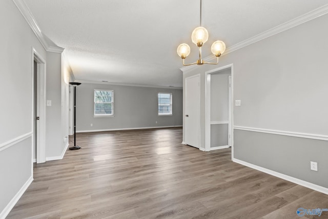 1201 Bailey Cove Cir SE # D, Huntsville, AL 35802 - unfurnished room featuring ornamental molding, a chandelier, wood finished floors, and baseboards