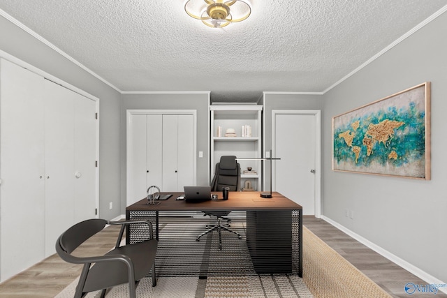 1201 Bailey Cove Cir SE # D, Huntsville, AL 35802 - office area with wood finished floors, a textured ceiling, ornamental molding, and baseboards