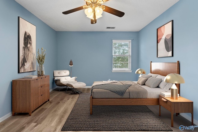 1201 Bailey Cove Cir SE # D, Huntsville, AL 35802 - bedroom with light wood-style floors, baseboards, and ceiling fan