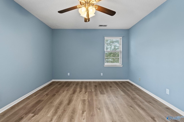 1201 Bailey Cove Cir SE # D, Huntsville, AL 35802 - unfurnished room with wood finished floors, a ceiling fan, baseboards, and a textured ceiling