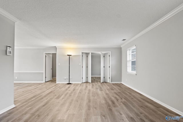 1201 Bailey Cove Cir SE # D, Huntsville, AL 35802 - unfurnished living room featuring crown molding, a textured ceiling, wood finished floors, and baseboards
