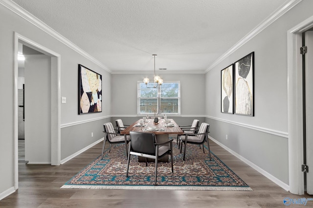 1201 Bailey Cove Cir SE # D, Huntsville, AL 35802 - dining space with wood finished floors, a chandelier, ornamental molding, a textured ceiling, and baseboards