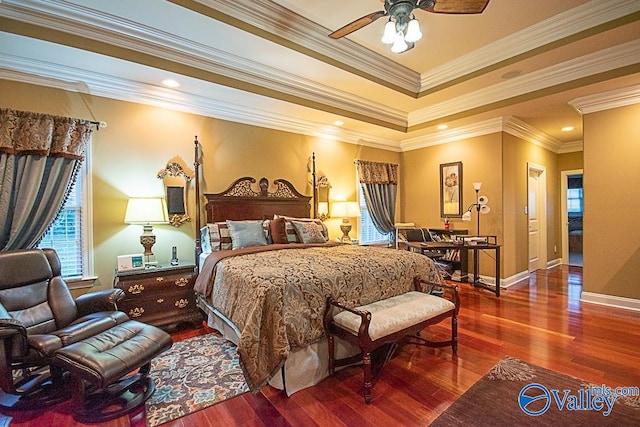 bedroom with ceiling fan, crown molding, hardwood / wood-style flooring, and a raised ceiling