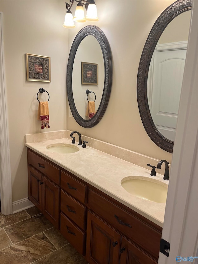 bathroom with tile patterned flooring and dual bowl vanity