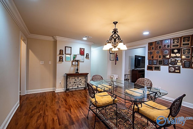 interior space with a notable chandelier, dark hardwood / wood-style flooring, and ornamental molding