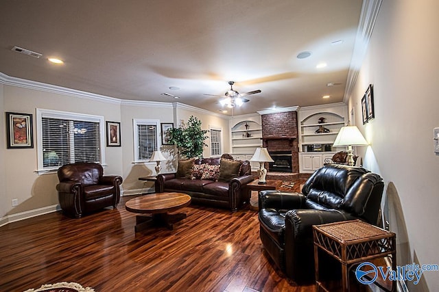 living room featuring ceiling fan, built in shelves, crown molding, brick wall, and dark hardwood / wood-style floors