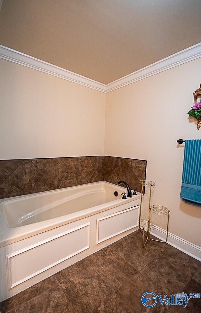 bathroom featuring tile patterned flooring, a bathing tub, and ornamental molding