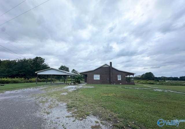 view of side of property featuring a gazebo and a yard