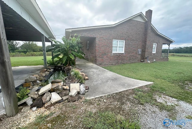 view of side of home with a lawn