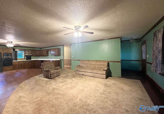 living room with a textured ceiling, crown molding, and ceiling fan