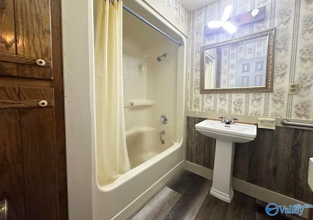 bathroom with shower / tub combo with curtain and hardwood / wood-style floors