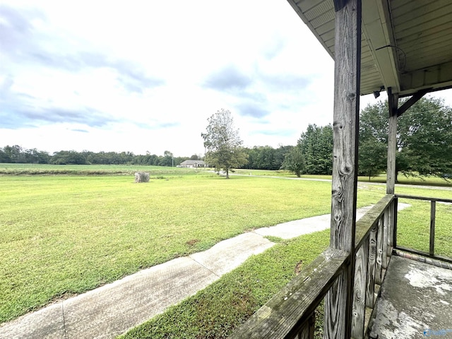 view of property's community featuring a rural view and a yard