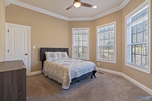 bedroom featuring baseboards, visible vents, a ceiling fan, crown molding, and dark carpet