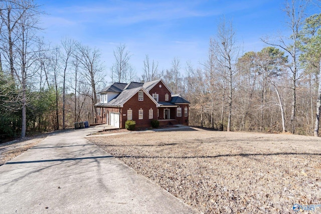 view of front of house with concrete driveway and brick siding