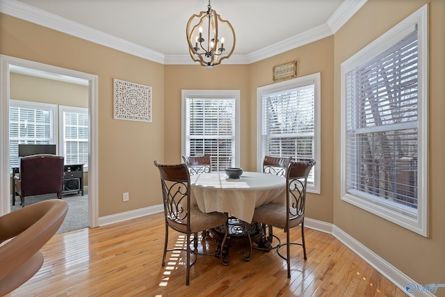 dining room with plenty of natural light, light wood-style flooring, and baseboards