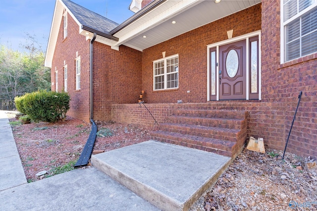 entrance to property featuring brick siding