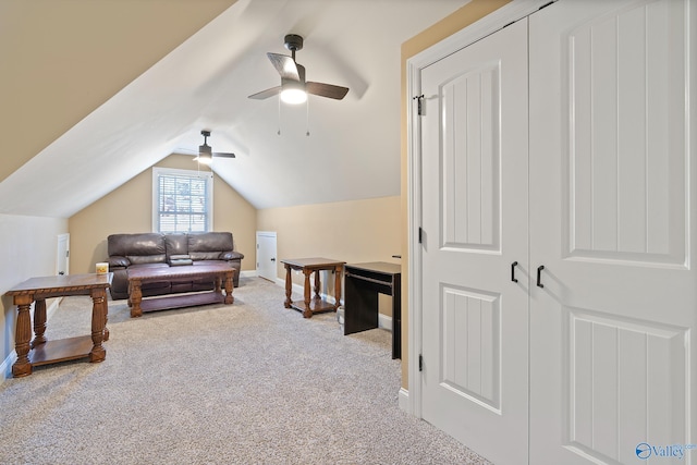 interior space featuring lofted ceiling, a ceiling fan, baseboards, and carpet flooring