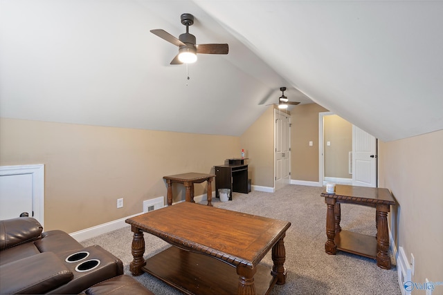 living room featuring baseboards, lofted ceiling, visible vents, and light colored carpet