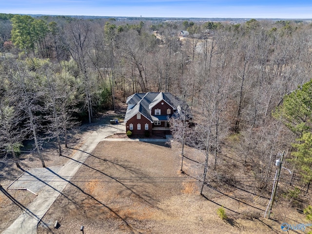 aerial view featuring a wooded view