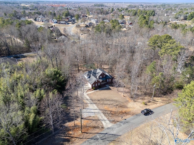 birds eye view of property featuring a wooded view