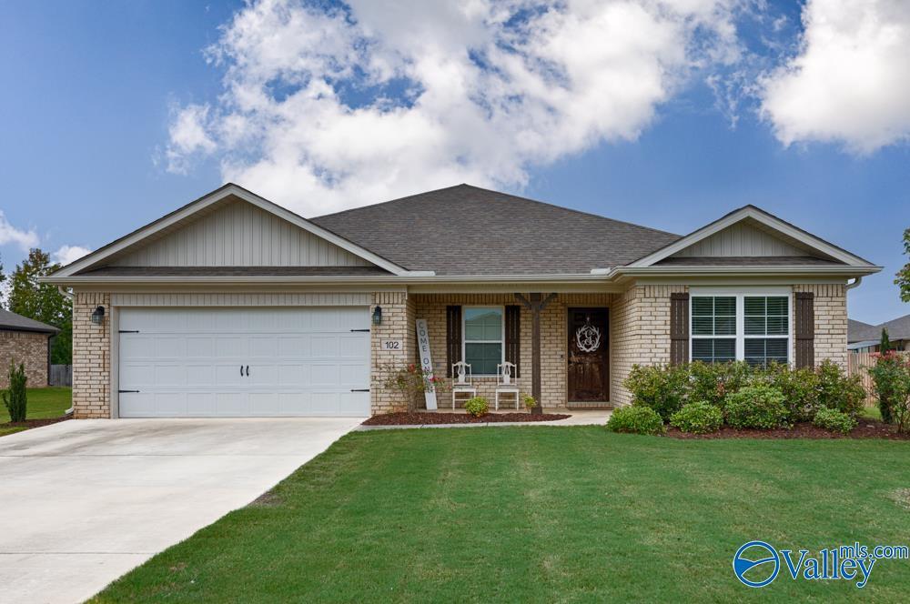 102 Lesson Cir, Owens Cross Roads, AL 35763 - single story home with brick siding, driveway, and a front yard