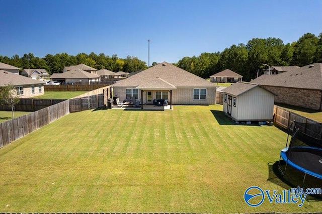 exterior space with a trampoline, a storage shed, and a patio area