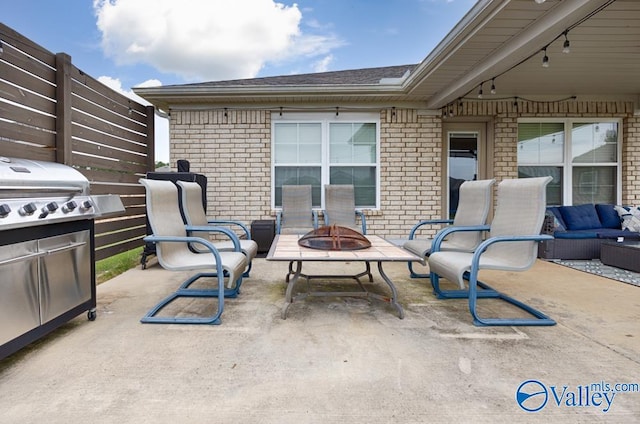 view of patio / terrace with an outdoor living space with a fire pit