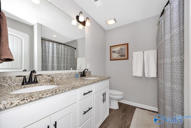 bathroom featuring a shower with curtain, wood-type flooring, toilet, and vanity