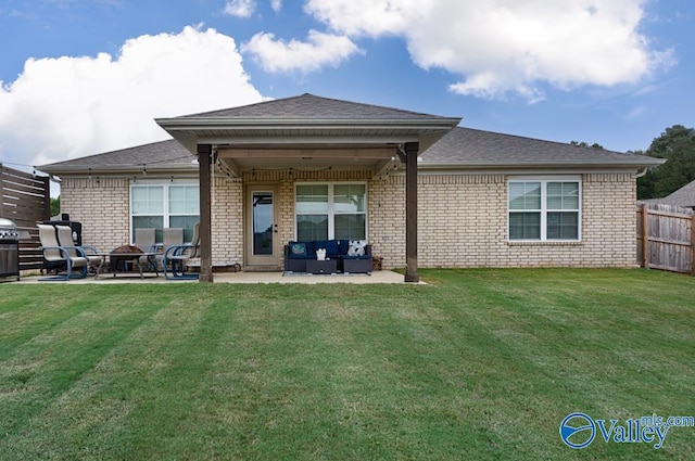 rear view of property with a lawn and a patio area