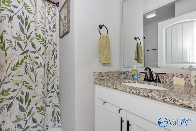 bathroom featuring vanity and a shower with curtain