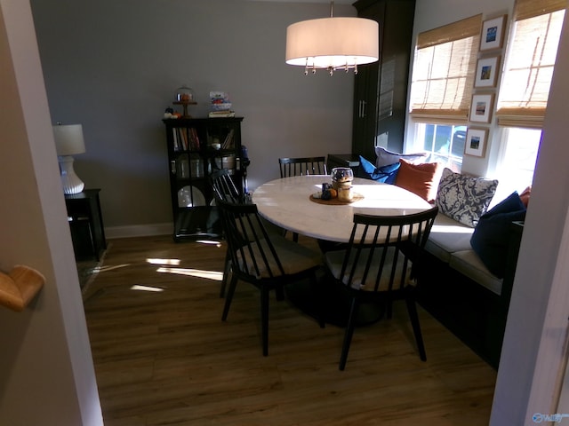 dining space with wood-type flooring