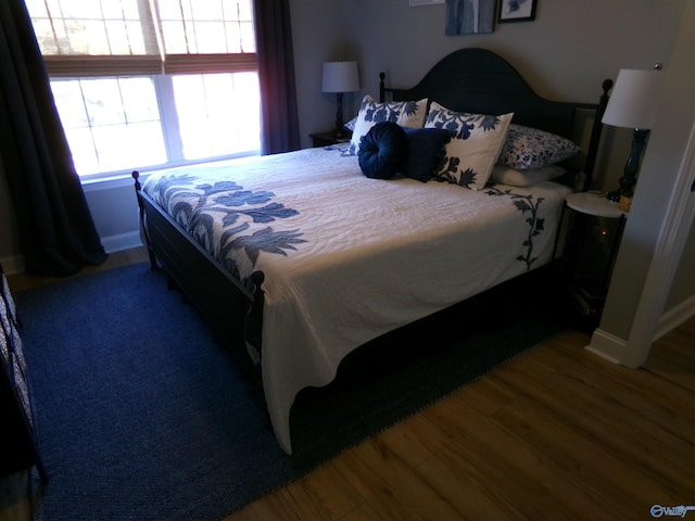 bedroom with dark wood-type flooring