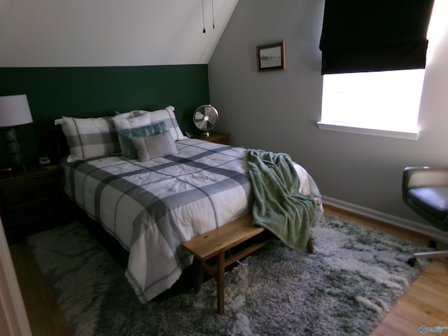 bedroom featuring lofted ceiling and wood-type flooring