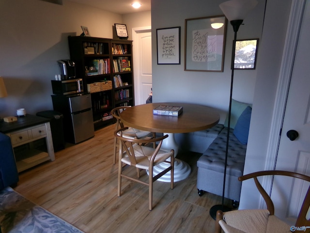 dining space with light hardwood / wood-style flooring