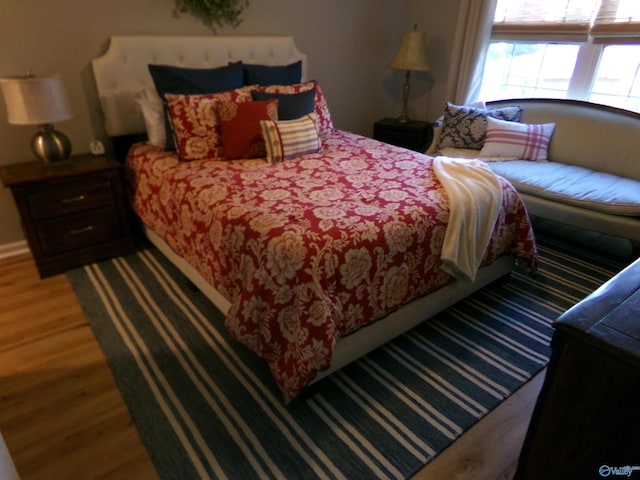 bedroom with dark hardwood / wood-style floors