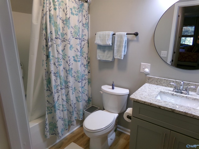 full bathroom featuring vanity, hardwood / wood-style floors, shower / bath combination with curtain, and toilet