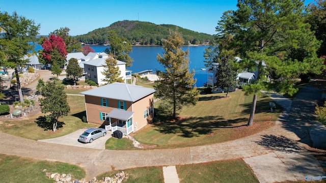 birds eye view of property with a water and mountain view