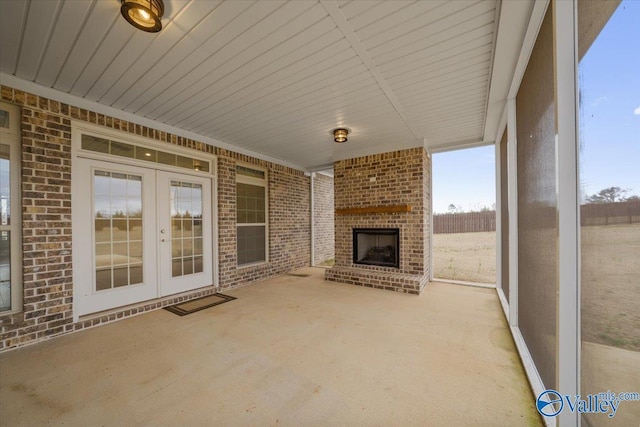 view of patio featuring an outdoor brick fireplace and french doors