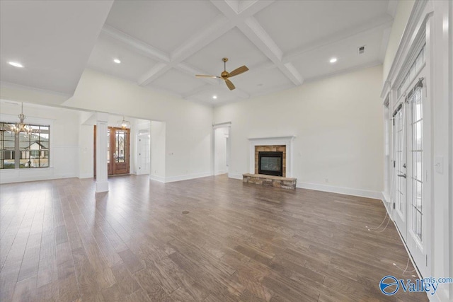 unfurnished living room with coffered ceiling, a fireplace, beam ceiling, and dark hardwood / wood-style flooring