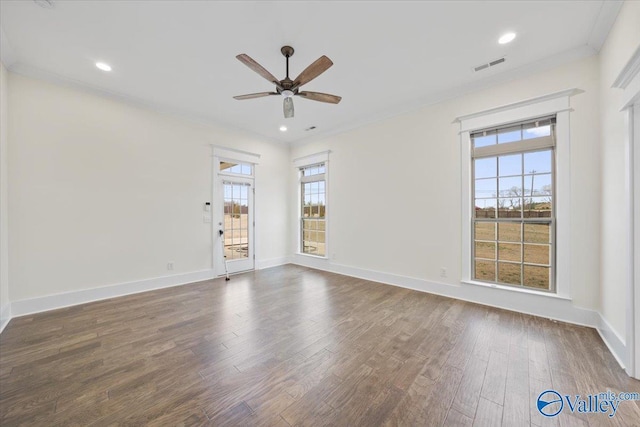 empty room with ceiling fan, ornamental molding, and dark hardwood / wood-style flooring