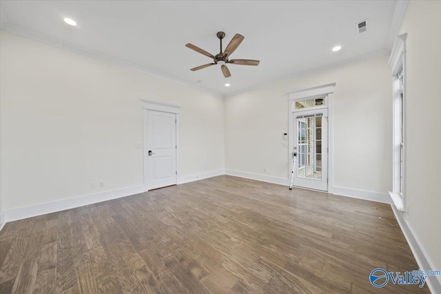 unfurnished room with ornamental molding, dark wood-type flooring, and ceiling fan