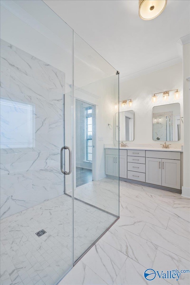 bathroom featuring crown molding, vanity, and a shower with shower door