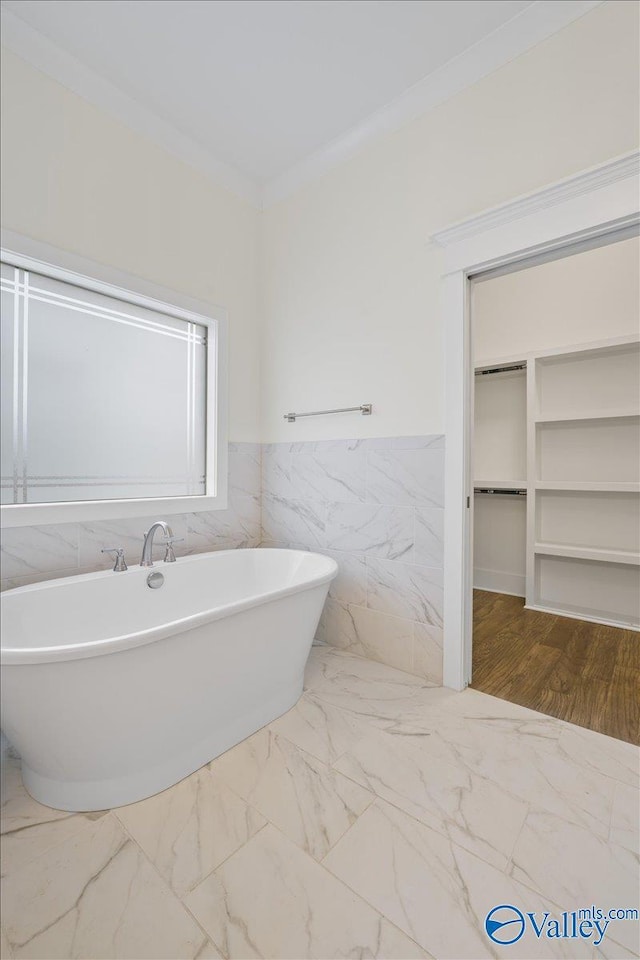 bathroom featuring a bathtub and ornamental molding