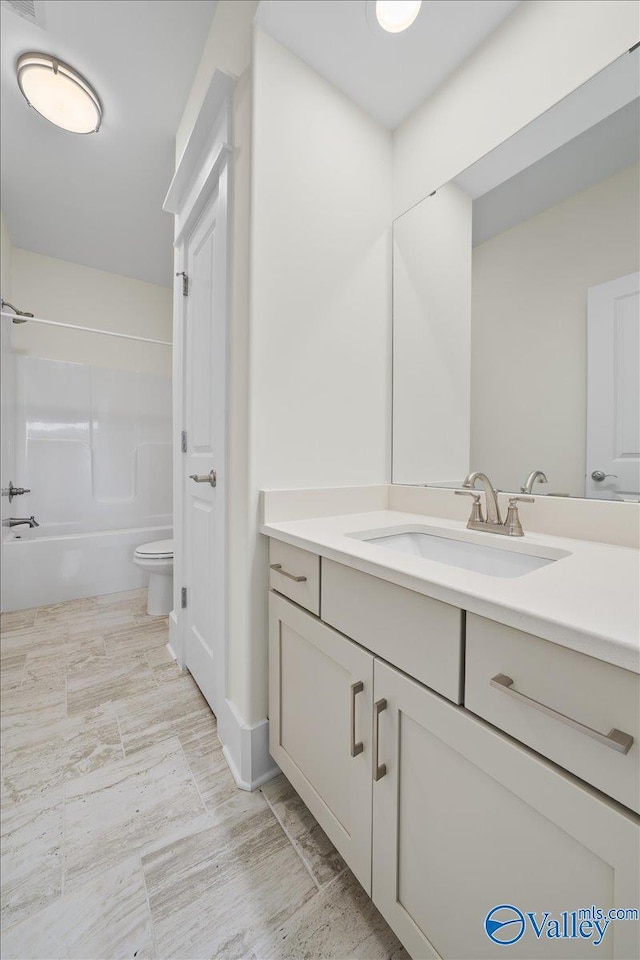 full bathroom featuring vanity, tub / shower combination, and toilet