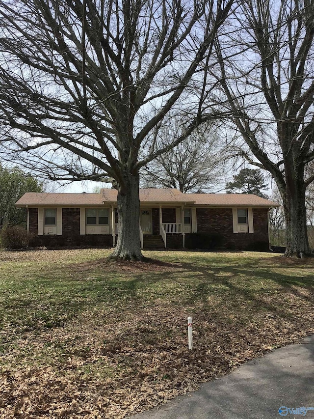 ranch-style home with a front lawn