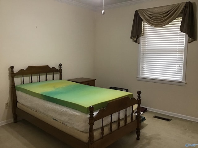 bedroom with crown molding and carpet floors